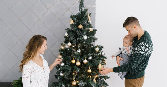 nice young family decorating their christmas tree for christmas